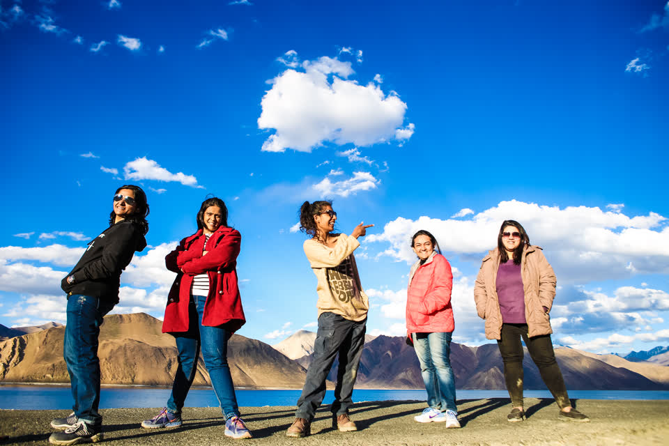 Five WOW Club travellers posing by a lake in Ladakh