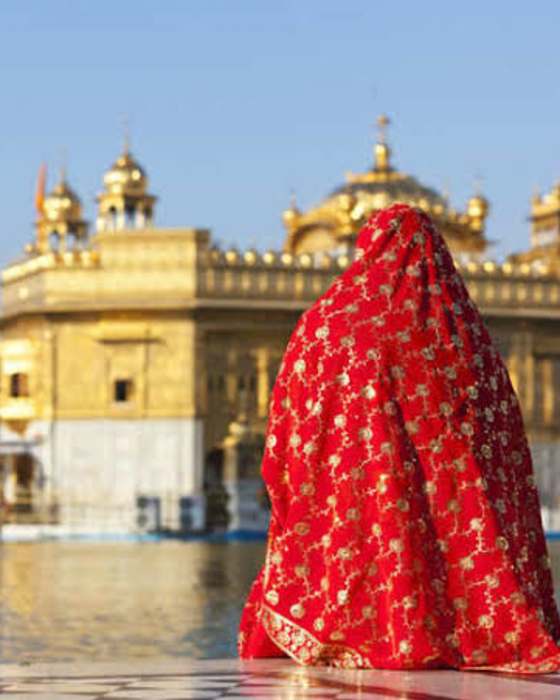 A woman in a red dupatta at the Golden Temple, Amritsar
